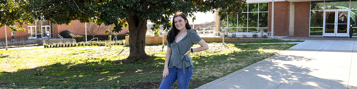 smiling student outside of library