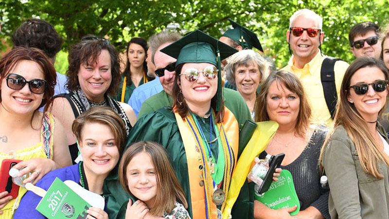 graduate with smiling family