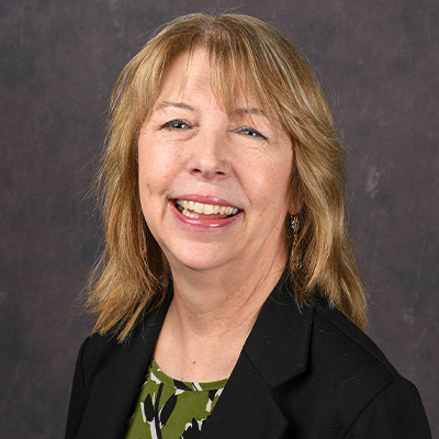 Profile photo Jill Riley, Executive Director of Strategic Planning and Institutional Effectiveness, in front of a professional backdrop.