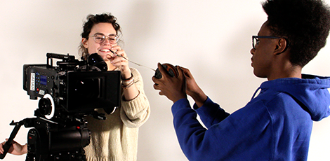Two students testing a camera and a microphone