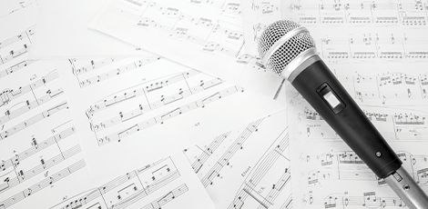 A microphone laying on sheet music