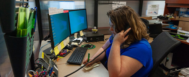 student worker helping someone on the phone