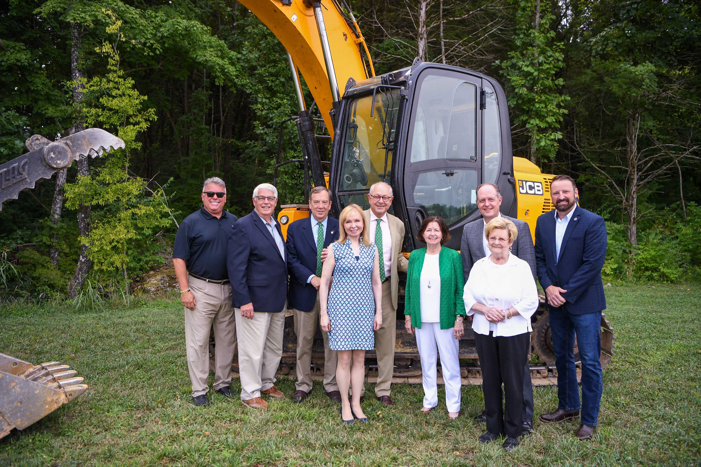 Group stands with excavator