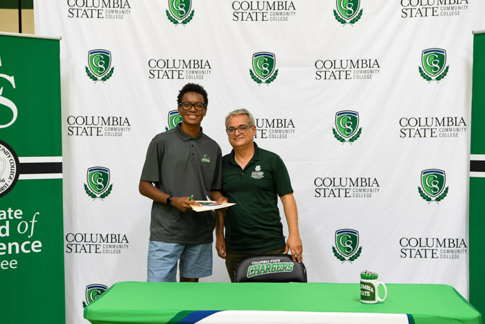 Pictured (left to right): Williamson County resident Jalen Jones signing to the engineering systems technology program with Mehran Mostajir, Columbia State program director of engineering systems technology.