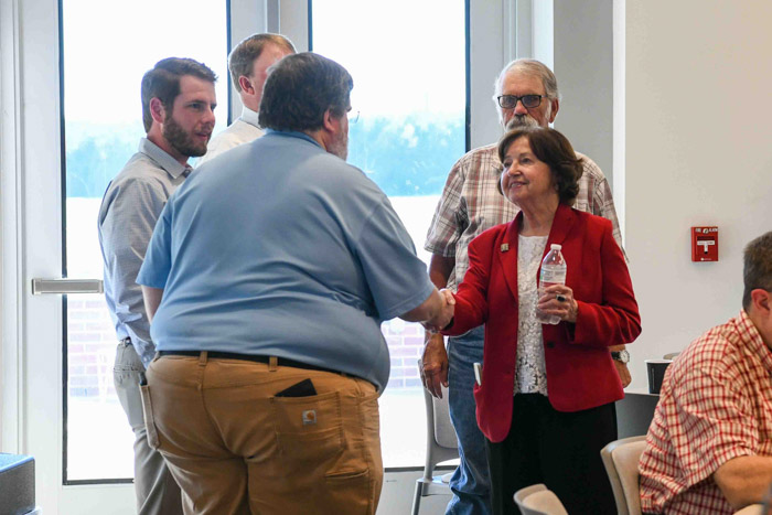 Dr. Janet F. Smith, Columbia State president (right), meets with community and local industry members at the EST Open House.