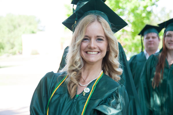 Blond girl wearing cap and gown