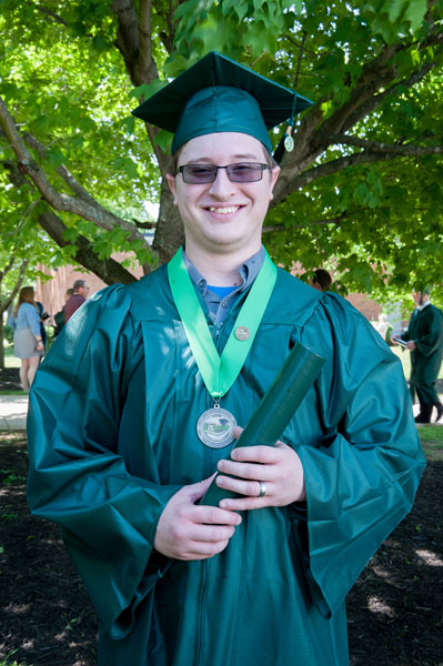 guy in green cap and gown