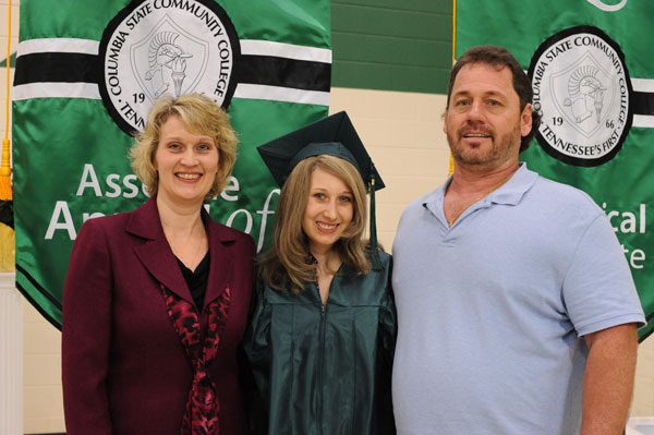 Female graduate with parents