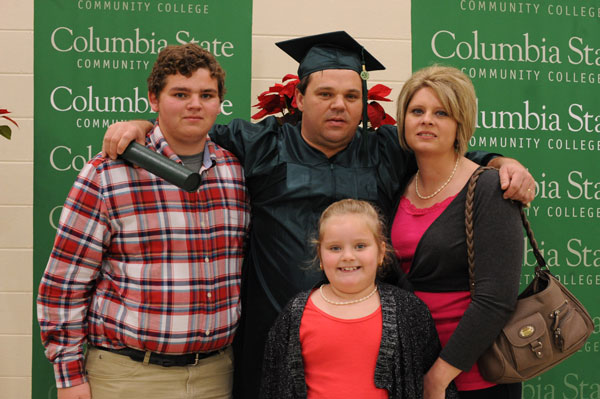 Male Graduate with his wife and kids