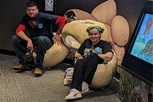 Two students sitting on a display